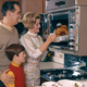 Family Thanksgiving turkey dinner being pulled from oven